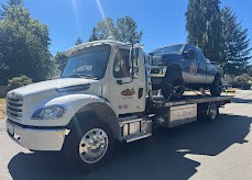 SafeTow flatbed carrying a pickup truck
